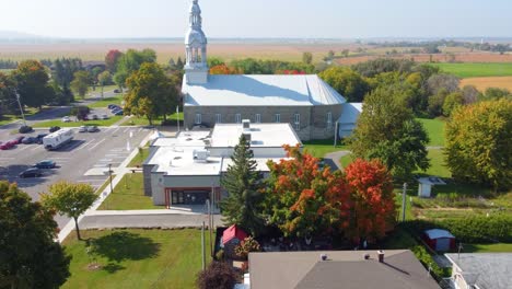 Aerial-Town-Church-and-parking-lot-during-autumn-day,-Montreal-Quebec-Canada