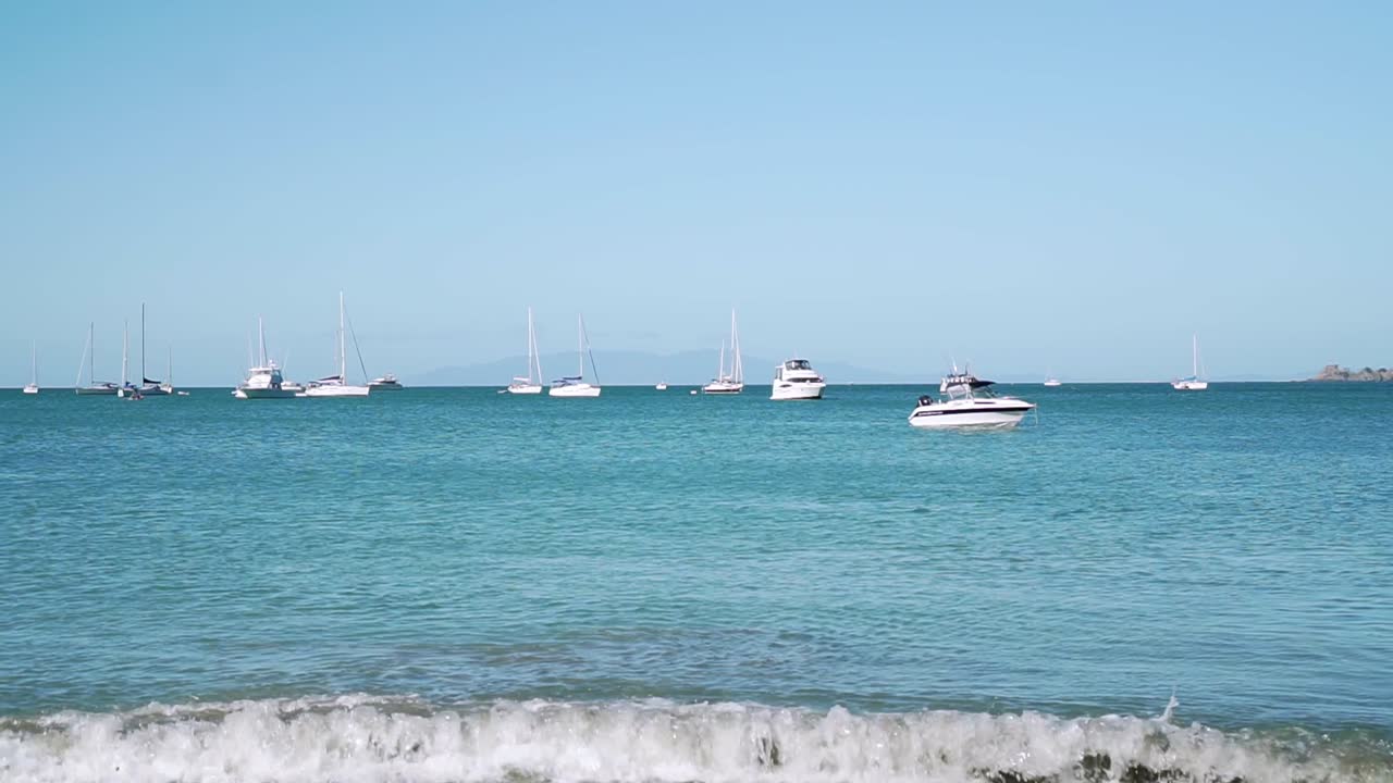 SLOWMO - Panning shot of yachts and sailboats in bay on Waiheke Island, New Zealand