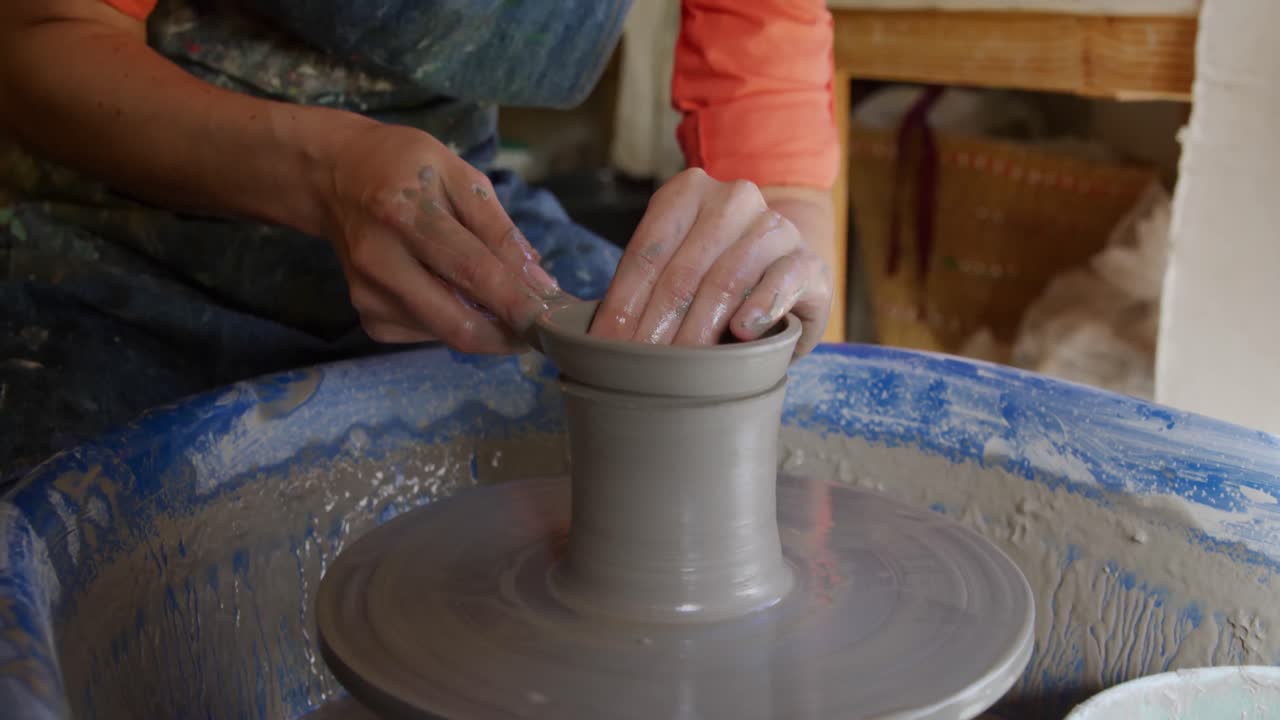 Young female potter working in her studio