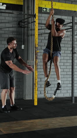 man training on climbing rope