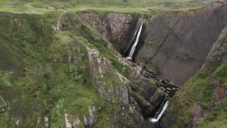 Dramatic-Aerial-Orbit-of-Speke's-Mill-Mouth-Waterfall,-Hartland,-North-Devon,-UK