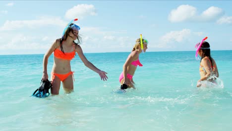 female caucasian sisters enjoying water fun with snorkels