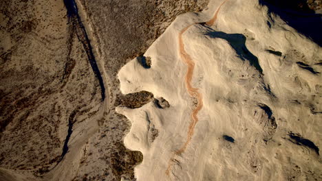a drone flies toward unusual rock formations near lake powell in page, arizona.