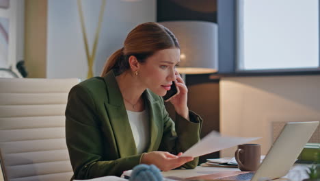 nervous designer talking mobile phone call evening office closeup. woman working