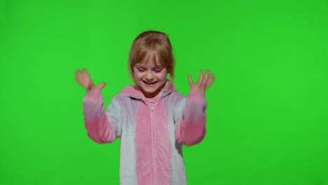 Little-blonde-child-girl-smiling,-dancing,-celebrating-in-unicorn-pajamas-costume-on-chroma-key