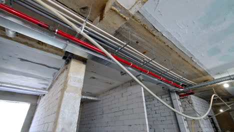 old building renovation. pipes and wires on the ceiling of the premises. low angle view.