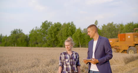 young farmers discussing at wheat field 13