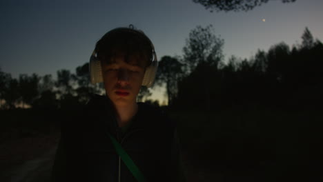 teenager walking in the woods at night