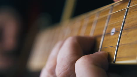 un guitarrista profesional toca una balada en una guitarra acústica marrón