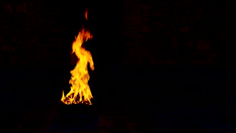 natural fire flame against dark black background.