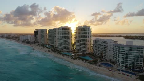 drone flies over hotels during gorgeous sunset in cancun, mexico