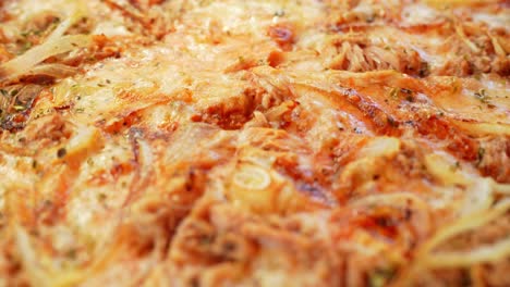 Closeup-detail-delicious-warm-Pizza-with-tuna-topping,-dolly-in-above-plate