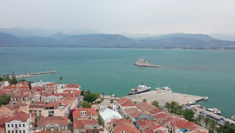 cityscape of nafplion picturesque town with sea and castle, greece