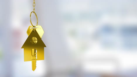 Animation-of-gold-house-key-fob-and-key-dangling-over-out-of-focus-interiors-with-copy-space