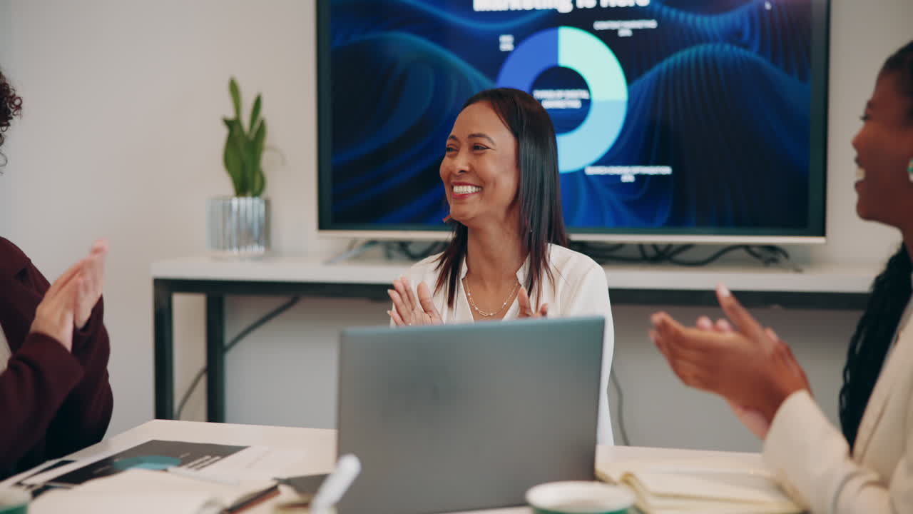 Diverse team celebrating success in a business meeting