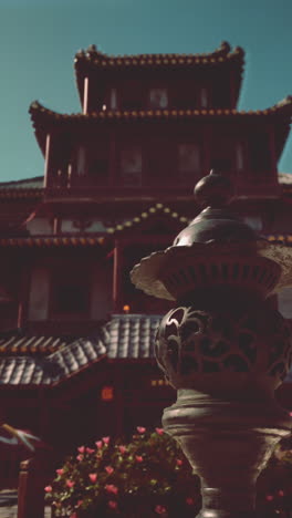 a chinese temple with a stone lantern in the foreground