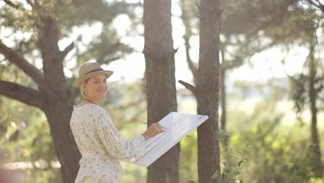 woman painting outdoors in a sunlit forest