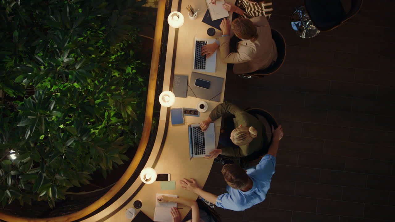 Team leader helping new employee in office. Smart people working together.