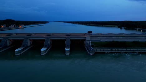 water spillways of hydroelectric plant on the danube river at sunset