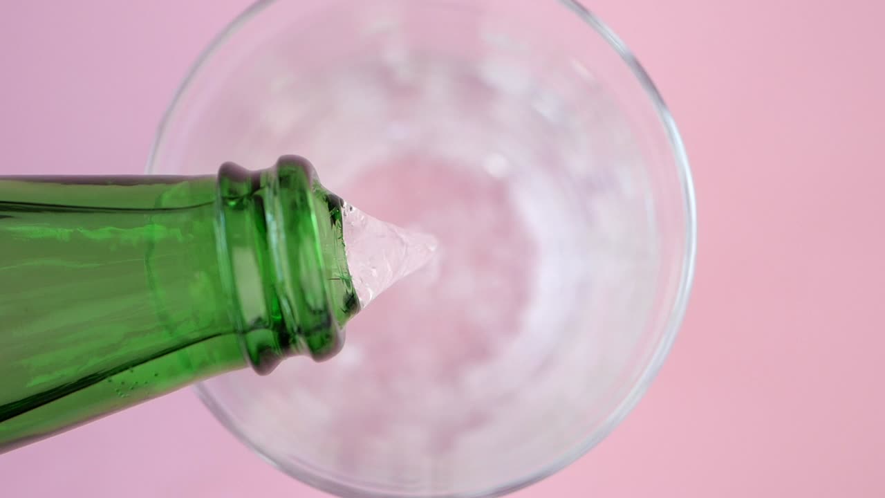 Pouring a drink into a glass bowl