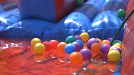 colourful balls rolling into a air slip and slide toy