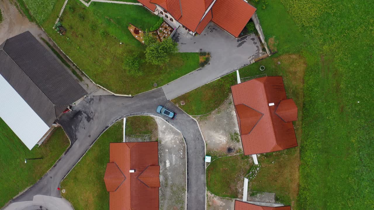 Drone aerial forward flying bird eye view of a small village with cluster of houses
