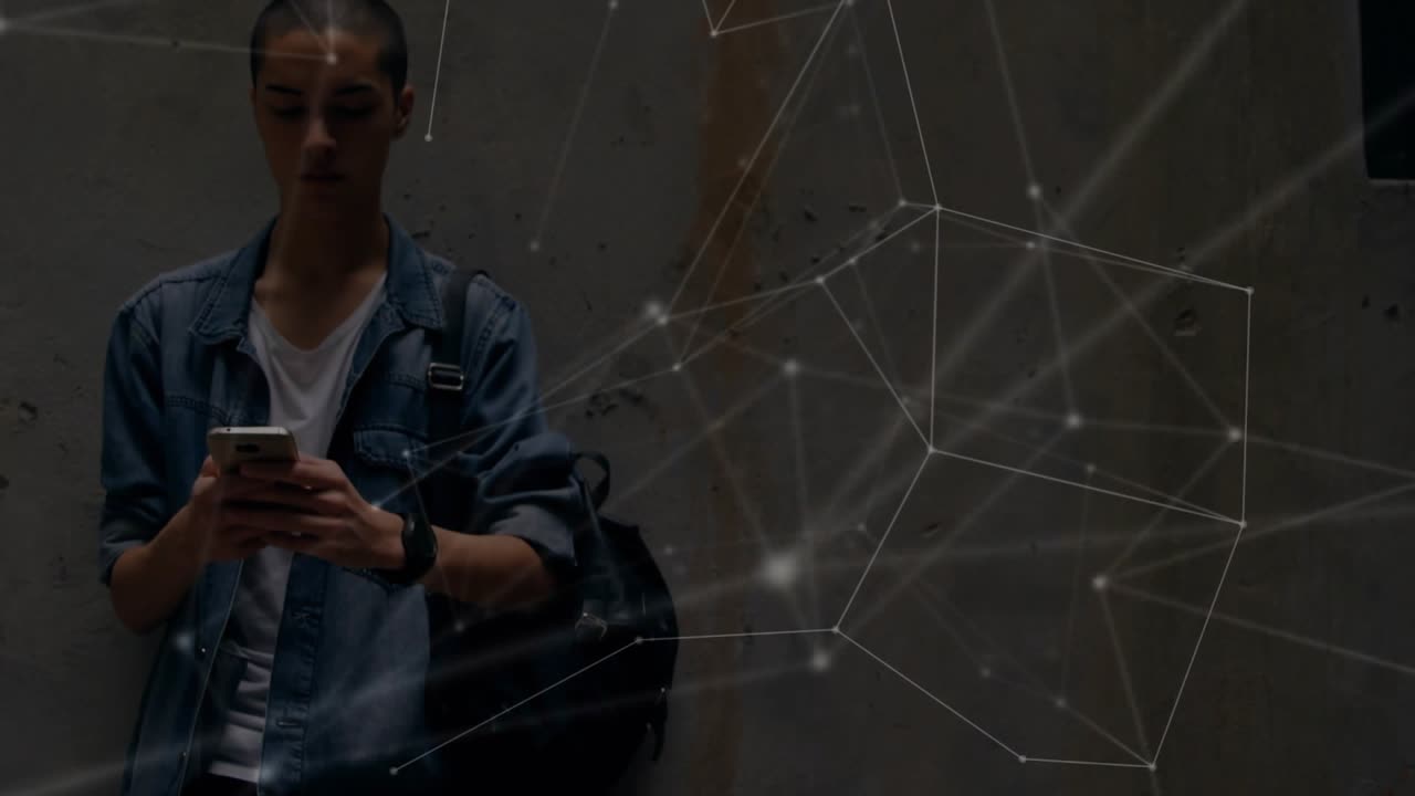 Man leaning against concrete wall tapping phone and revealing animated network cube for tech demo