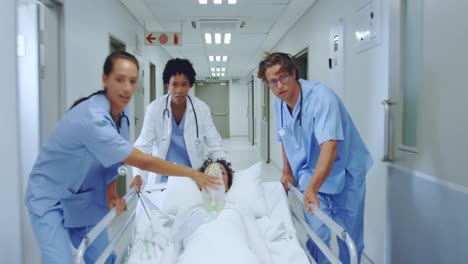 -medical-team-pushing-emergency-stretcher-bed-in-the-corridor-at-hospital