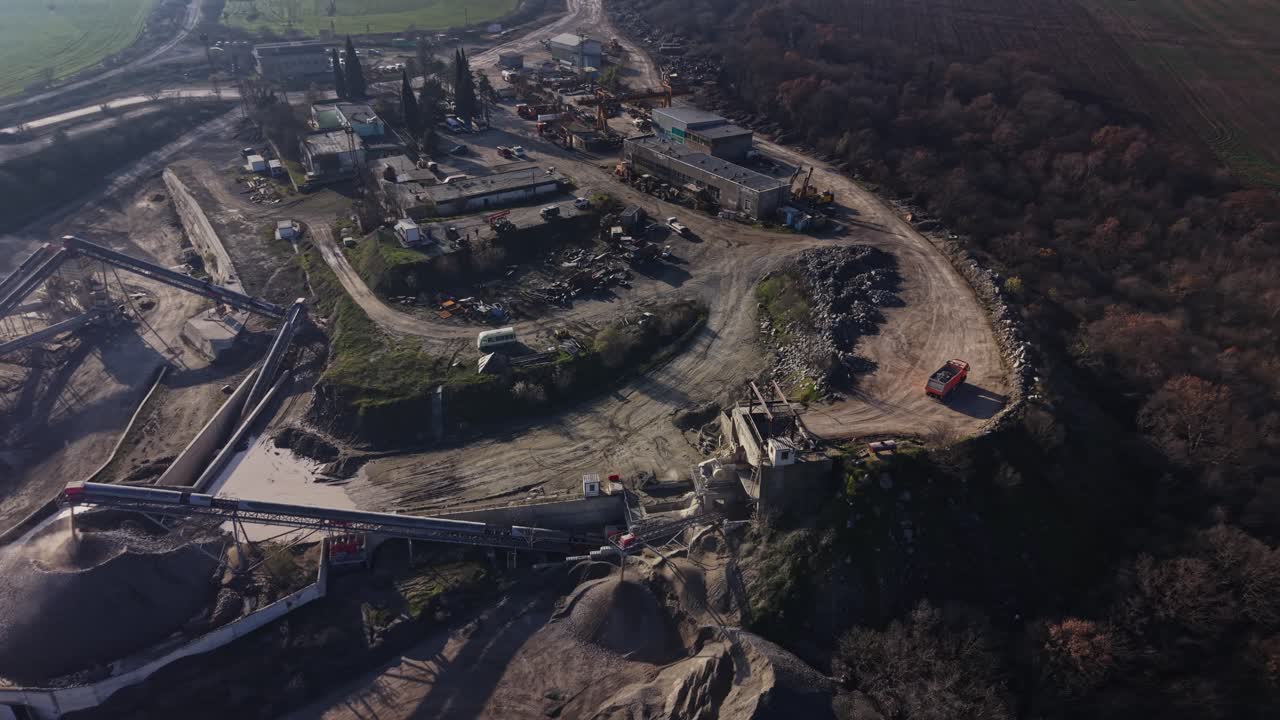 Quarry site shows heavy machinery and mining equipment at work