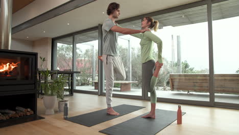 couple practicing yoga together at home, enjoying peaceful morning by fireplace