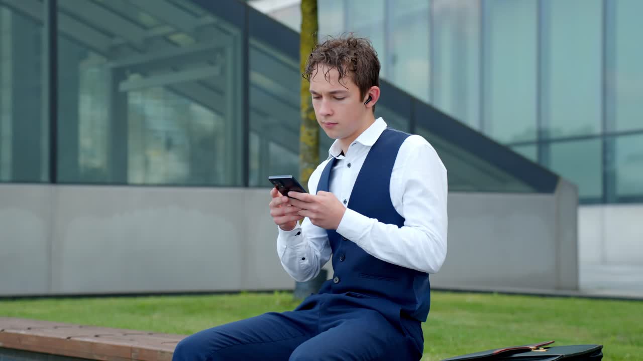 Young financial analyst sitting outdoors, using smartphone for business communication, managing investments, and staying connected with work, slow motion static shot