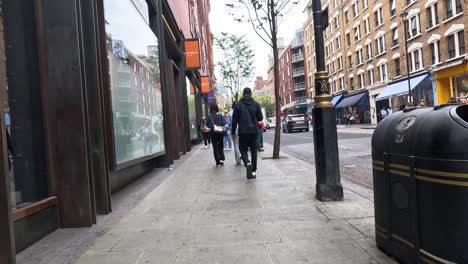 pedestrians walking along a bustling city street