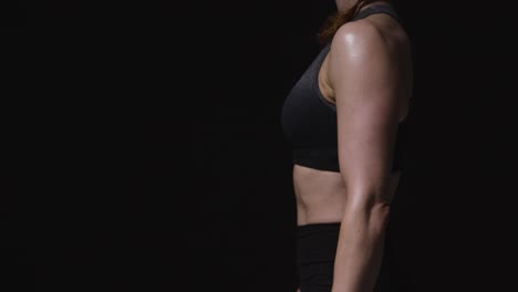 Close-Up-Studio-Shot-Showing-Abdomen-Of-Mature-Woman-Wearing-Gym-Fitness-Clothing-Doing-Stretching-Exercises