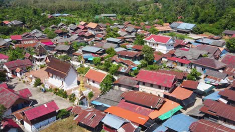 aerial flying over tin rooftops of whiskey village in luang prabang, laos