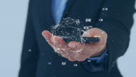 animation of globe of network of connections over mid section of a businessman using a smartphone