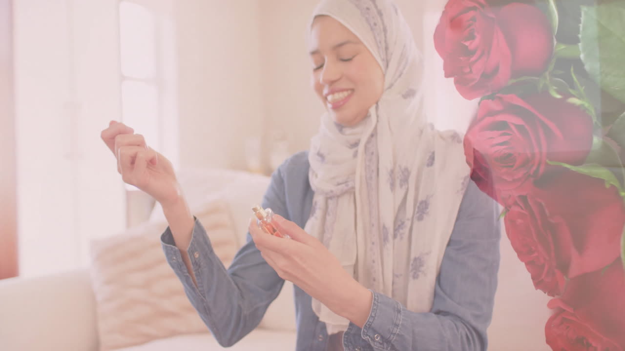 animación de rosas rojas sobre mujer biracial en hijab sonriendo y usando perfume