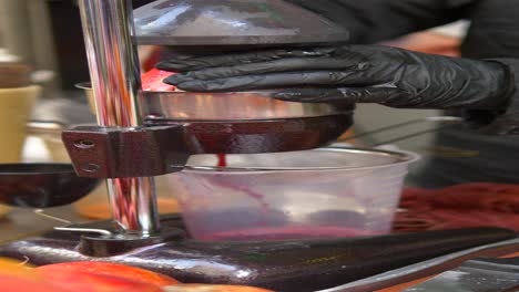 fresh pomegranate juice being made