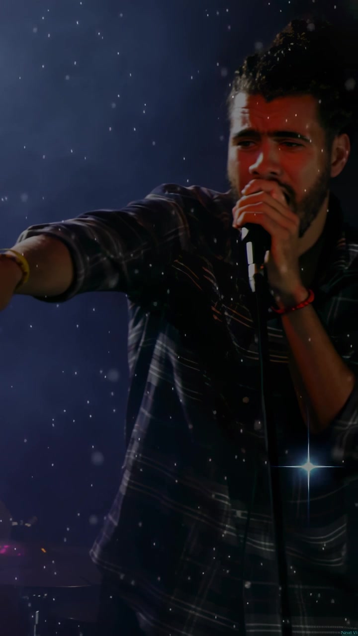 Vertical video: Camera panning, singer at mic, pointing and singing to engage music fans with stars