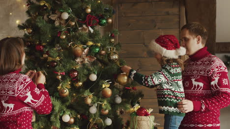 familia feliz decorando el árbol de navidad en casa