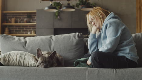 red haired woman watch her dog bulldog