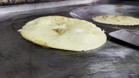 cooking a tortilla on a griddle