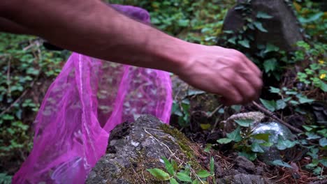 person picking up empty bottle and garbages during early morning in manali, himachal pradesh india. - wide shot