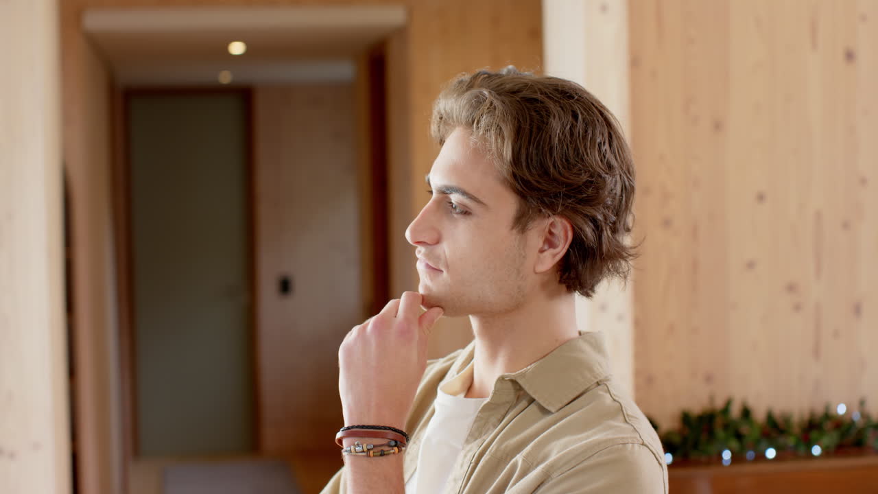 Contemplating holiday decorations, thoughtful man at home during Christmas season