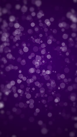 watercolor popping purple cute polka dots. chaotic movement of white blurred snow round spots. loop animation. vertical video.