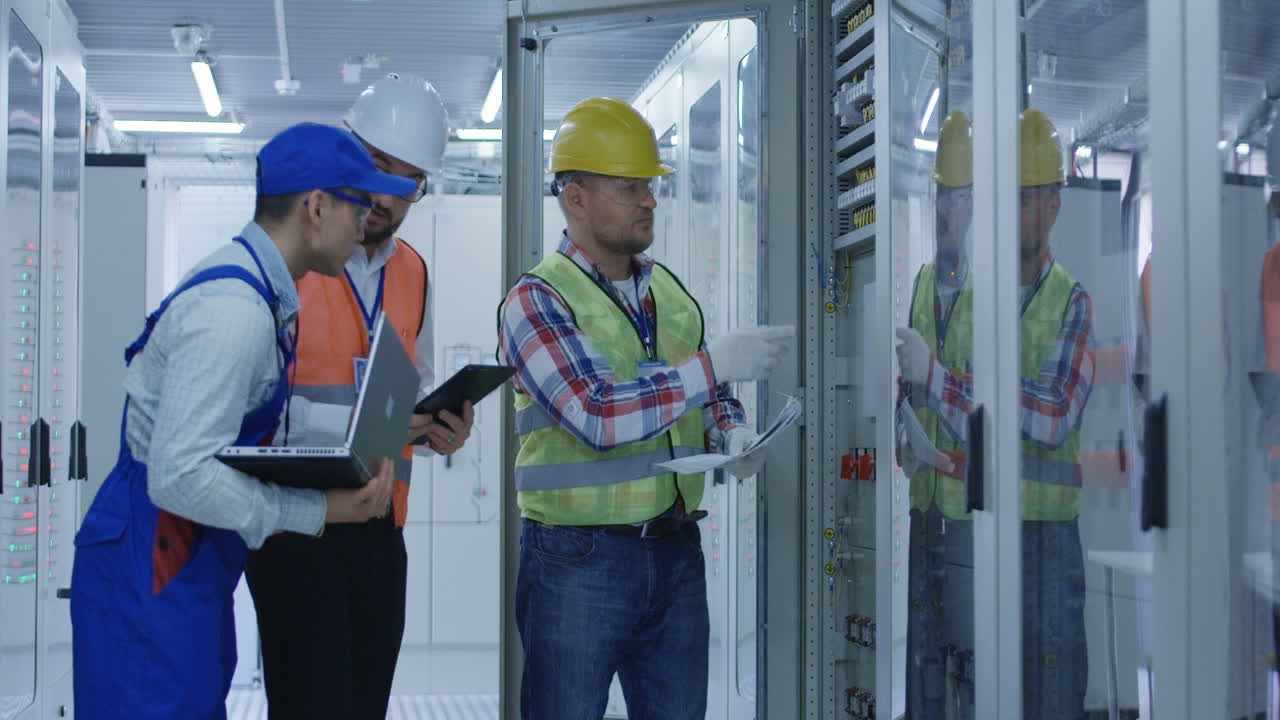 Electrical Engineers Reviewing Documents at a Power Station