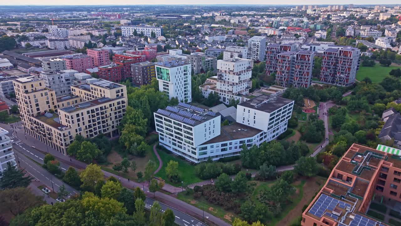 Aerial drone view of modern residential architecture in the La Courrouze eco-district of Rennes, France. Sustainable apartment buildings and green parks characterize this urban development