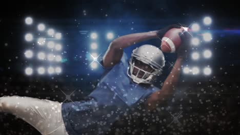 digital composite video of silver sparkles moving against male rugby player catching a rugby ball