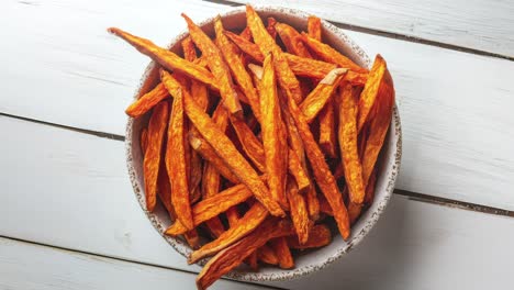 bowl of crispy sweet potato fries on wooden table