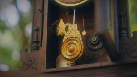 antique pendulum clock in a forest wooden door open low angle close up pendulum shot slow motion