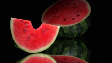 piece of watermelon with a bite being taken by a man's hand